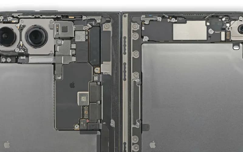 Foldable phone opened up to show its internals: dual-camera module, motherboard, battery compartments and front camera.
