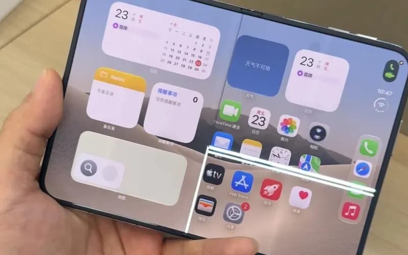 Hand holding a foldable phone showing an iOS-style home screen with calendar and notes widgets and app icons