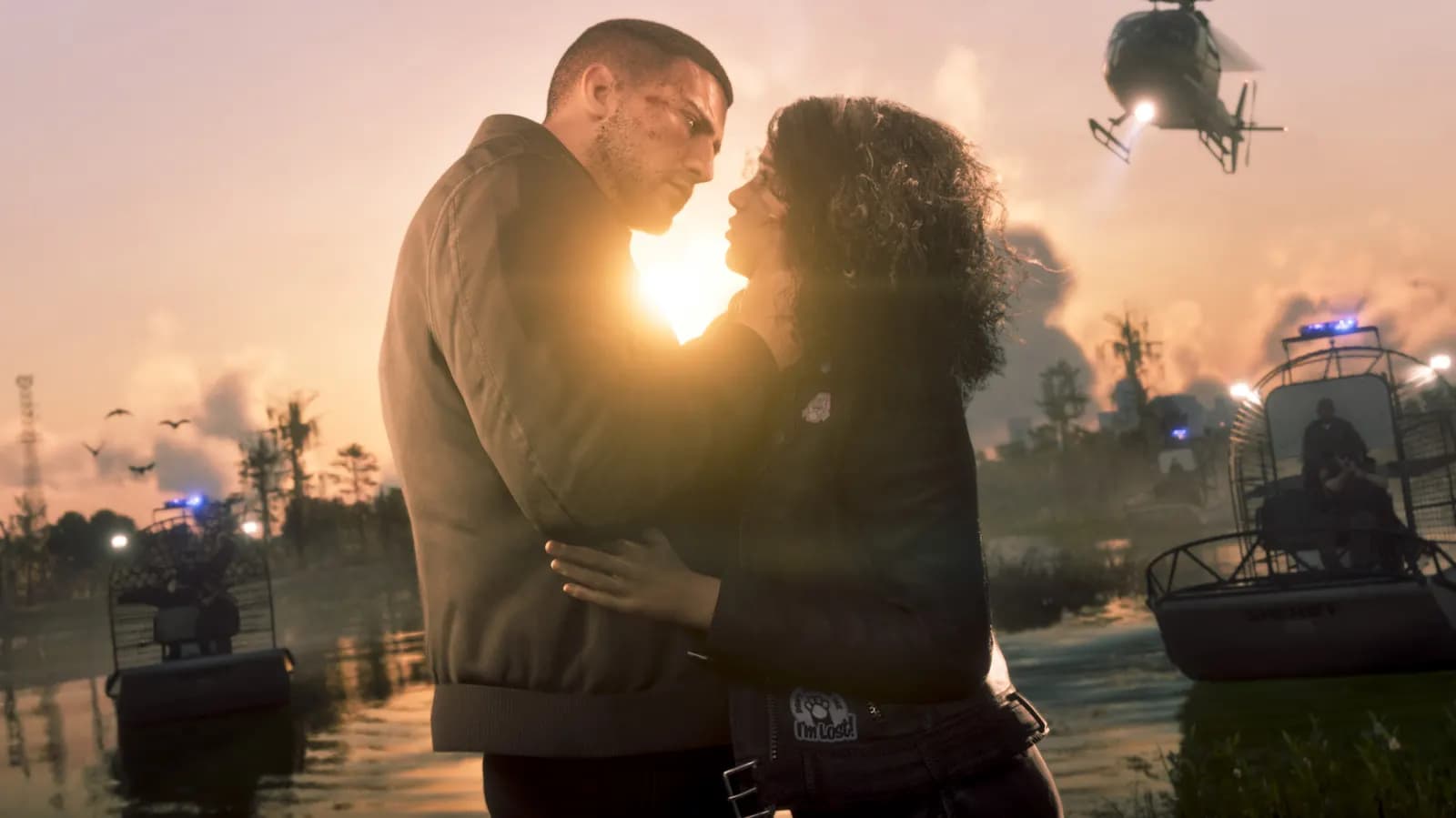 A couple embraces in a marsh at sunset, with police boats behind them and a helicopter overhead.