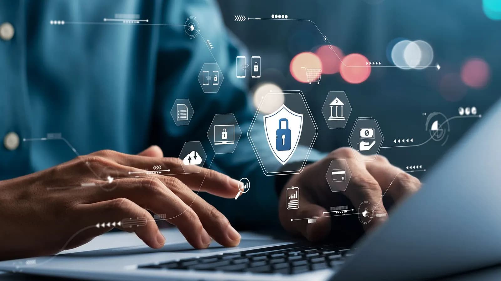 Hands typing on a laptop, with lock, shield, bank, and cloud icons overlaid to represent cybersecurity